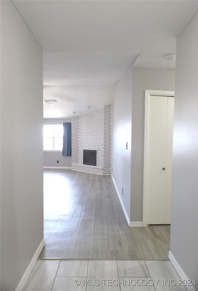 unfurnished living room featuring light wood-type flooring and a fireplace