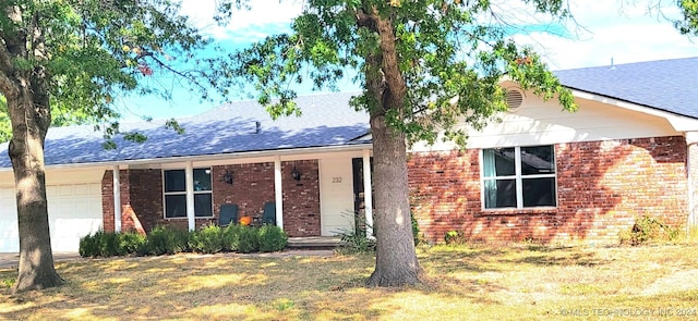 single story home with a garage and a front lawn