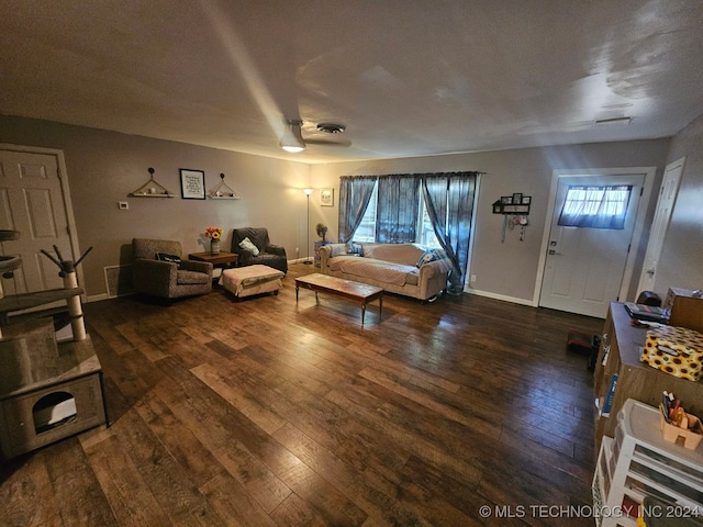 living room featuring ceiling fan and dark hardwood / wood-style flooring