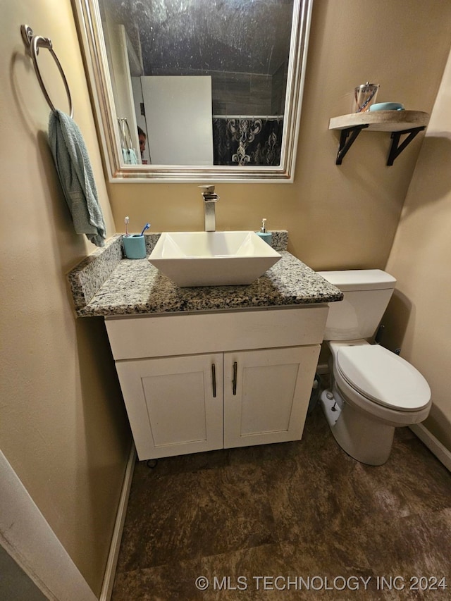 bathroom featuring vanity and toilet