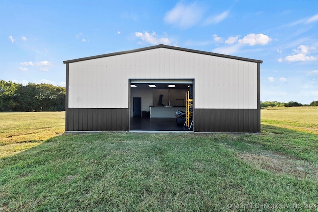 garage featuring a lawn and wooden walls