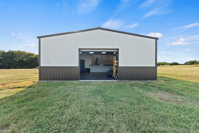 garage featuring wooden walls and a lawn