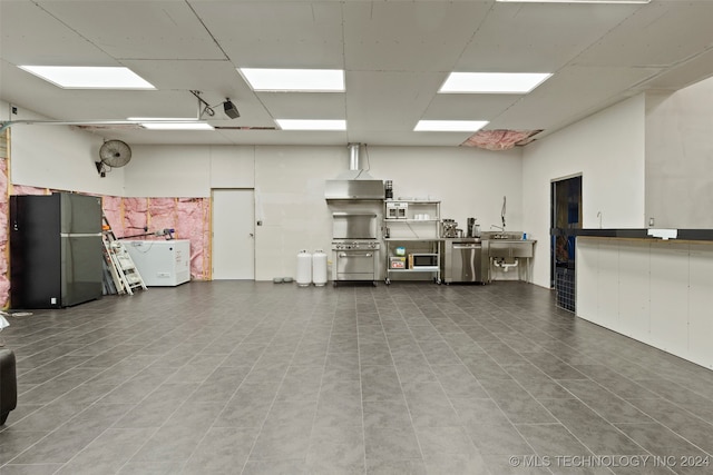 garage featuring black refrigerator and sink