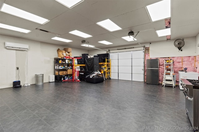 garage featuring stainless steel refrigerator and a wall unit AC