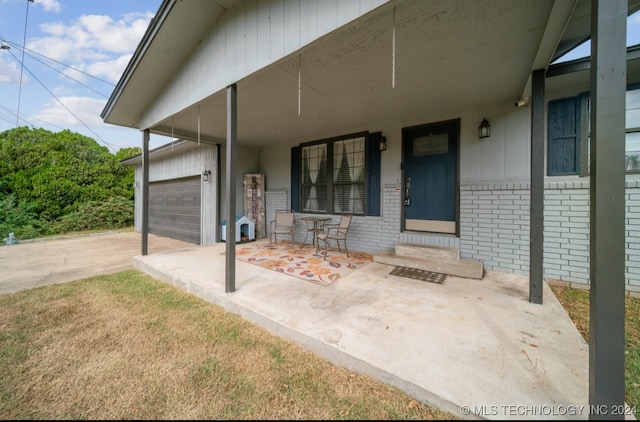 view of exterior entry with covered porch