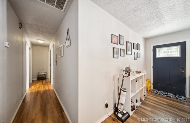 foyer featuring a textured ceiling and hardwood / wood-style floors