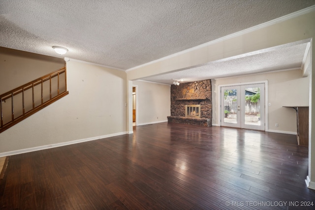 unfurnished living room with a textured ceiling, ornamental molding, and a fireplace