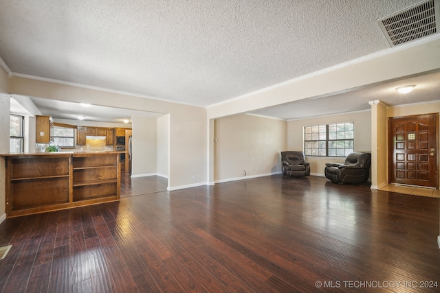 unfurnished living room featuring a textured ceiling, crown molding, and dark hardwood / wood-style floors