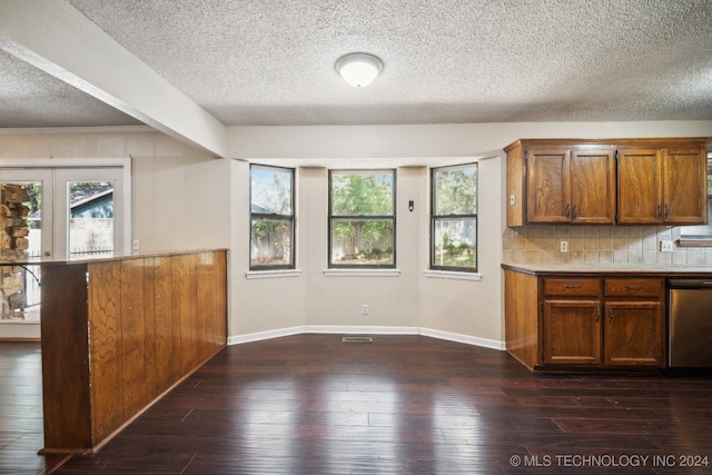 kitchen with a textured ceiling, dishwasher, french doors, backsplash, and dark wood-type flooring