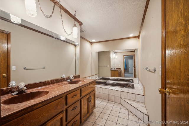 bathroom featuring tile patterned flooring, vanity, ornamental molding, a bathing tub, and a textured ceiling