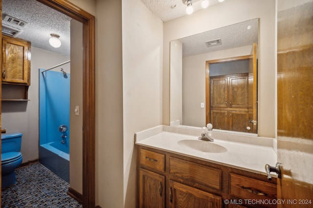 full bathroom with a textured ceiling, washtub / shower combination, tile patterned floors, and vanity