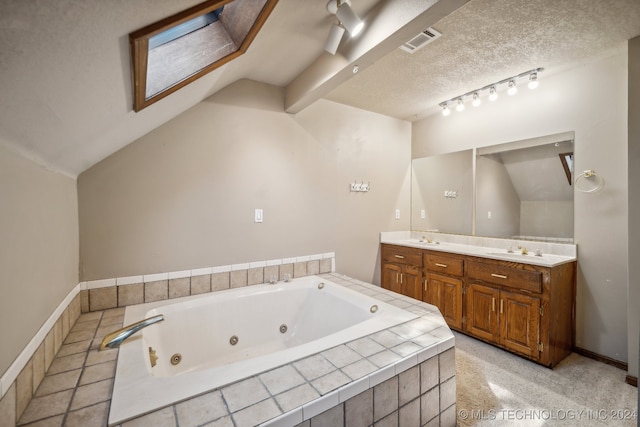 bathroom featuring a textured ceiling, lofted ceiling, vanity, and a relaxing tiled tub