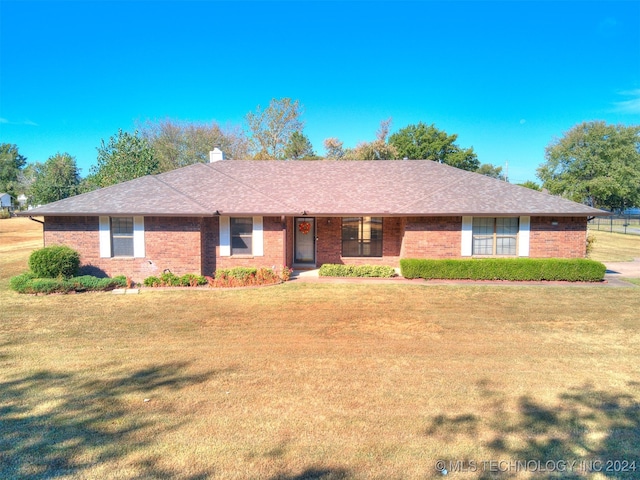 ranch-style house with a front lawn