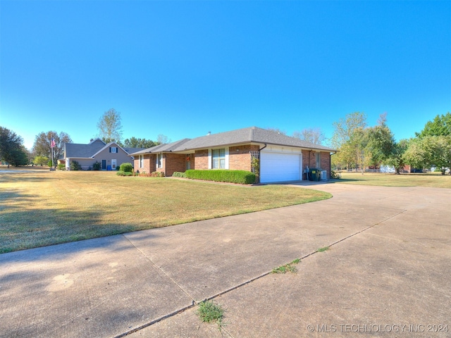 single story home with a front yard and a garage