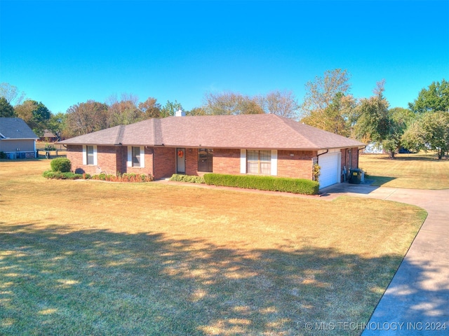 ranch-style home with a garage and a front lawn