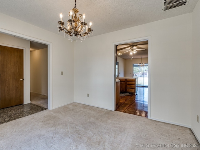 spare room featuring a textured ceiling, carpet flooring, and ceiling fan with notable chandelier