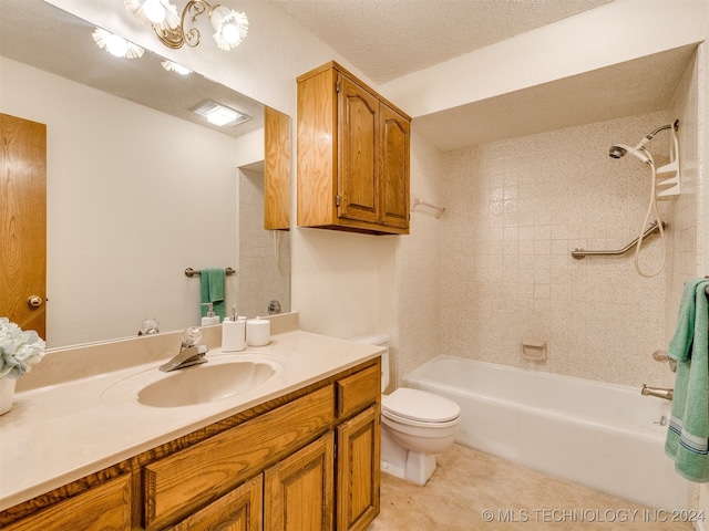 full bathroom with vanity, toilet, tiled shower / bath combo, and a textured ceiling