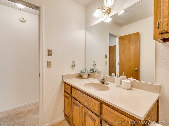 bathroom featuring vanity and a textured ceiling