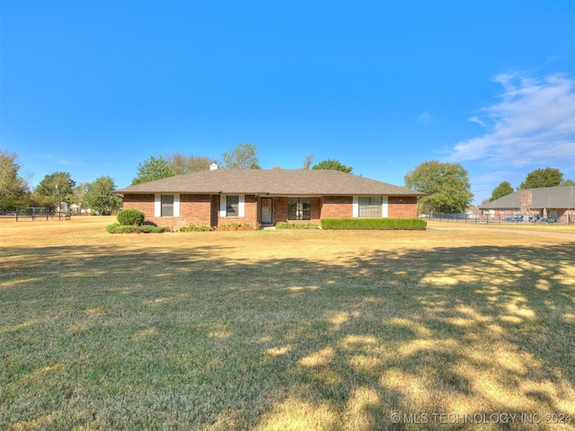 ranch-style house with a front lawn