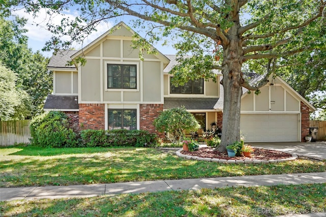 english style home with a garage and a front yard