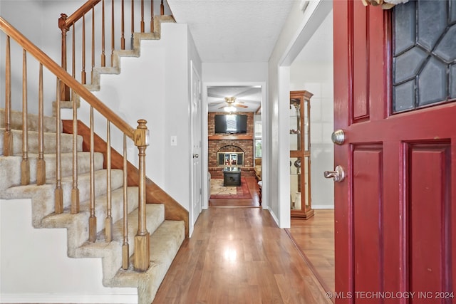 entrance foyer with light hardwood / wood-style floors and a textured ceiling