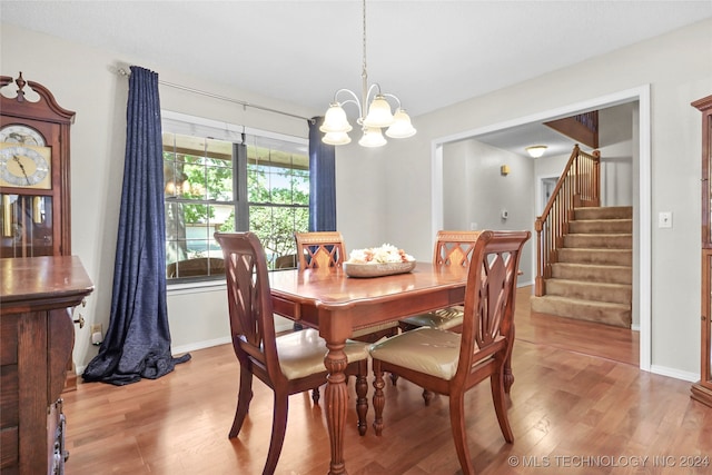 dining space featuring light hardwood / wood-style flooring and a notable chandelier