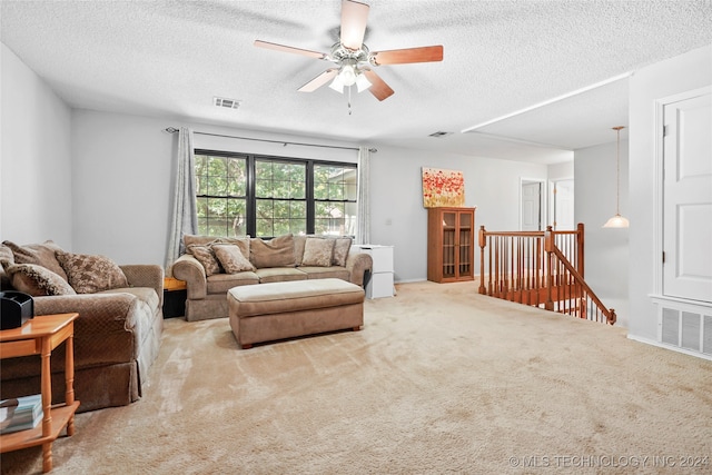 living room featuring light colored carpet and a textured ceiling