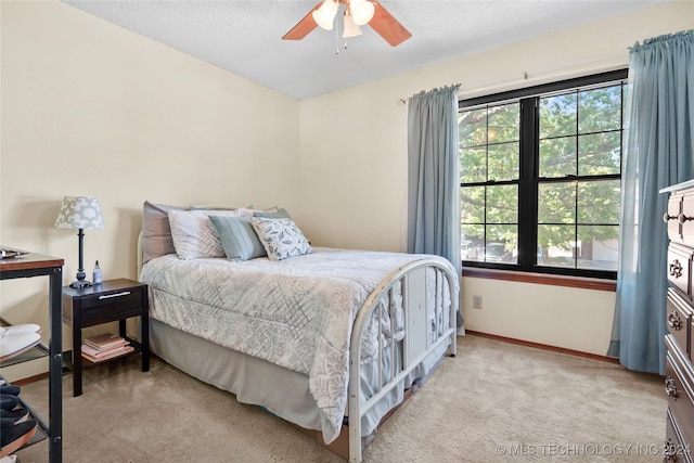 bedroom featuring ceiling fan and light carpet