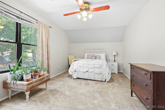 bedroom featuring ceiling fan, light colored carpet, and lofted ceiling