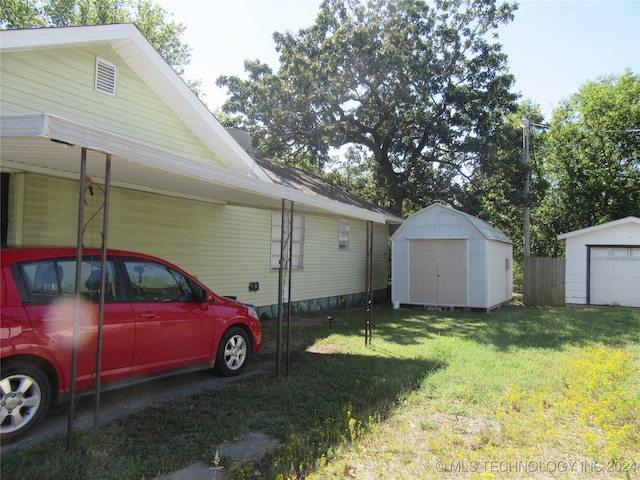 view of yard with a storage shed and a garage