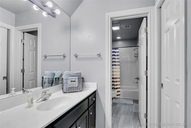 bathroom featuring vanity and shower / bath combo with shower curtain