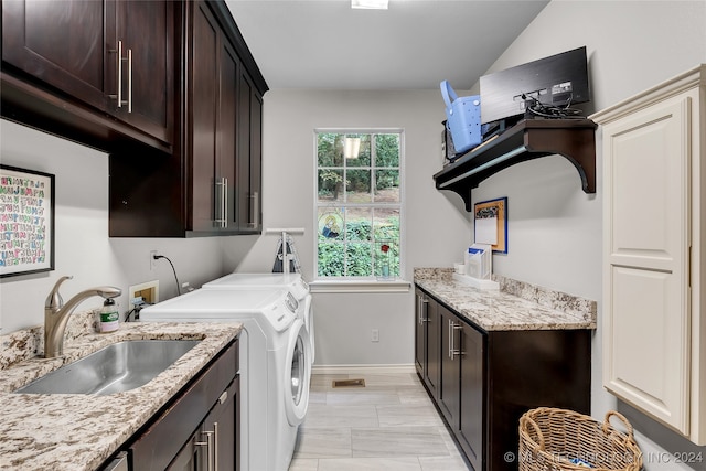 washroom with separate washer and dryer, cabinets, and sink