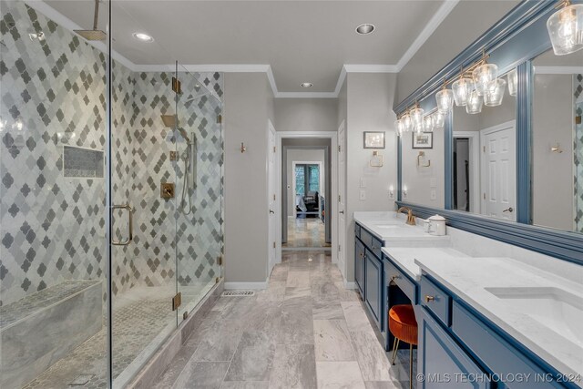 bathroom featuring vanity, a shower with shower door, and ornamental molding