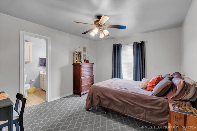 bedroom with wood-type flooring, ceiling fan, and ensuite bathroom