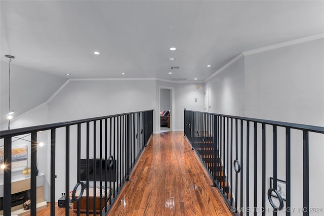 hall featuring wood-type flooring and crown molding