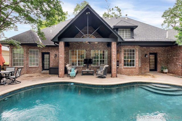 view of pool featuring ceiling fan, an outdoor living space, and a patio