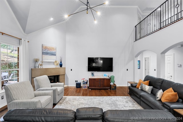 living room with ornamental molding, high vaulted ceiling, and hardwood / wood-style flooring