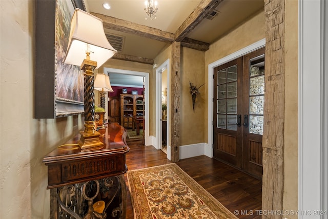 foyer with dark hardwood / wood-style flooring, french doors, and beamed ceiling