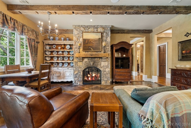 living room featuring a fireplace, a chandelier, and beamed ceiling