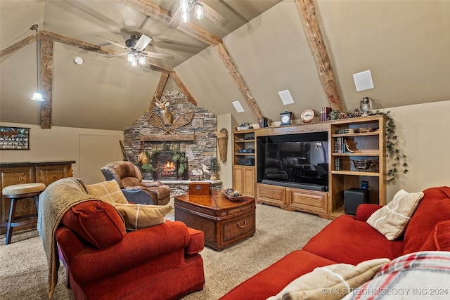 carpeted living room featuring ceiling fan, a stone fireplace, and high vaulted ceiling