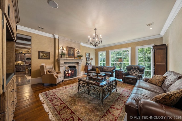 living room featuring dark hardwood / wood-style flooring, a large fireplace, an inviting chandelier, and ornamental molding