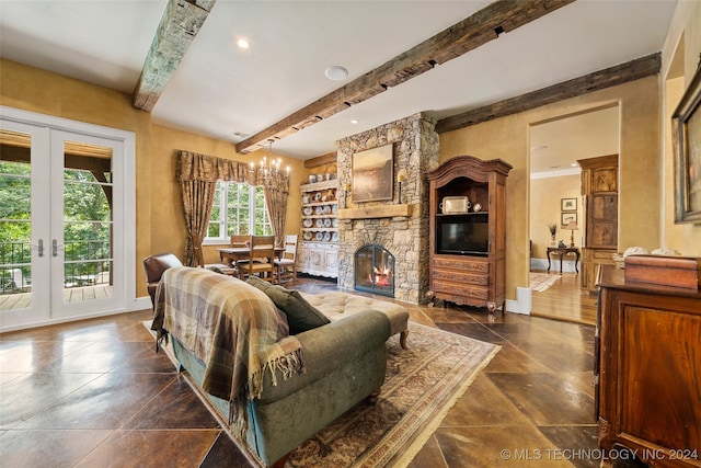 living room featuring beamed ceiling, french doors, a stone fireplace, and a notable chandelier