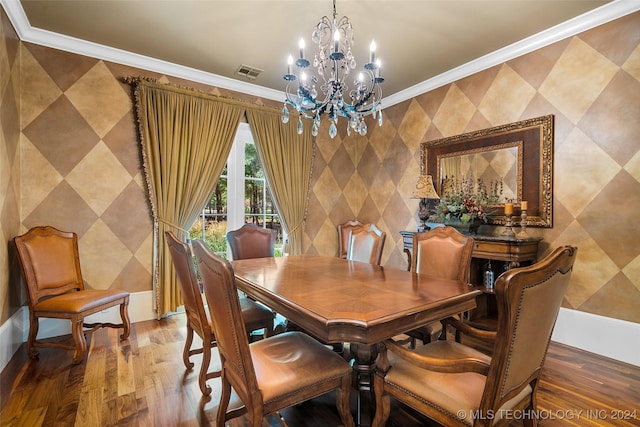 dining space with hardwood / wood-style flooring, a chandelier, and ornamental molding