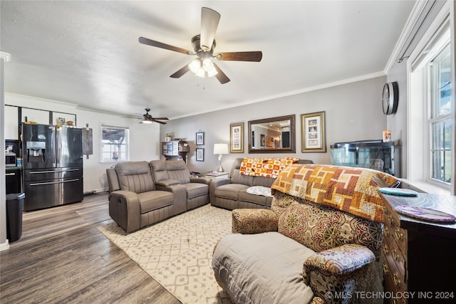 living room with ornamental molding, hardwood / wood-style floors, ceiling fan, and a wealth of natural light