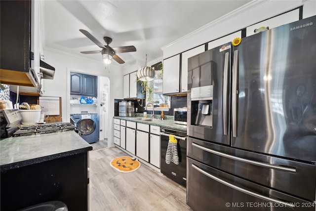 kitchen featuring washer / dryer, sink, stainless steel appliances, crown molding, and ventilation hood