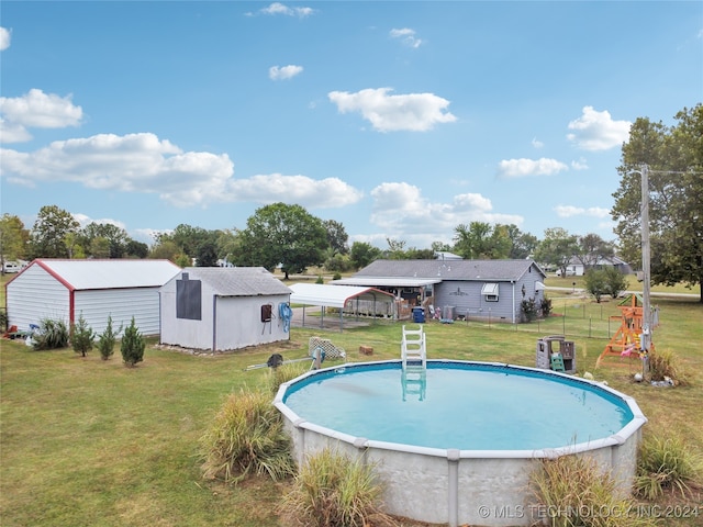 view of swimming pool with a storage shed and a lawn