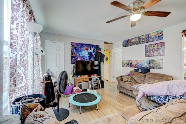 living room with ceiling fan and hardwood / wood-style flooring