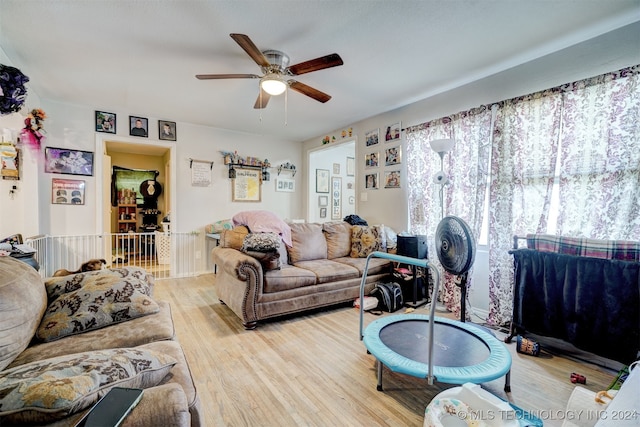 living room with light hardwood / wood-style floors and ceiling fan