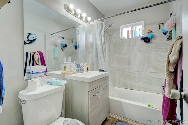 full bathroom featuring shower / tub combo, vanity, and toilet