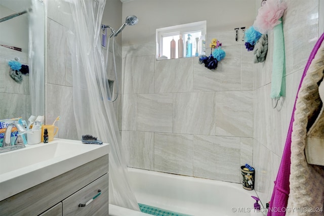 bathroom featuring shower / tub combo with curtain and vanity